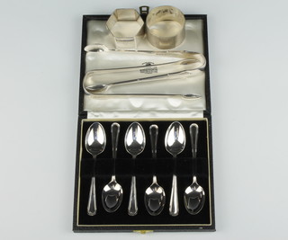 A pair of Victorian silver bright cut sugar tongs London 1892, a pair of Victorian silver sugar tongs Sheffield 1892, a cased set of 6 silver coffee spoons Sheffield 1961 and 2 silver napkin rings 184 grams 
