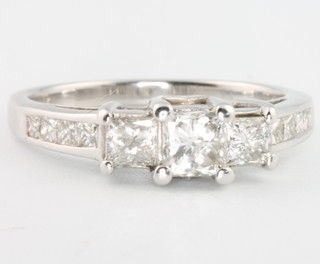 A 14ct white gold princess cut three stone diamond ring, approx 1.3ct, size Q