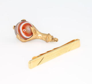 A Victorian gilt and agate charm together with a gilt tie pin