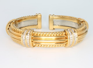 An 18ct yellow gold diamond set Etruscan style bangle with a steel sprung core
