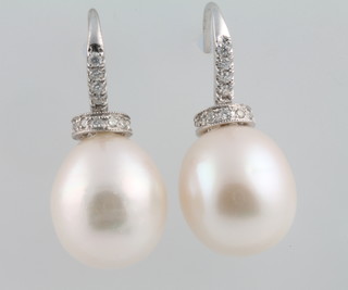 A pair of 18ct white gold cultured pearl and diamond earrings, the pearl 0.38ct
