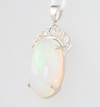 A 14ct white gold cabochon cut oval opal pendant surmounted by 7 brilliant cut diamonds the opal approx. 14.11ct, the diamonds measuring 22mm x 14mm approx. 0.37ct 