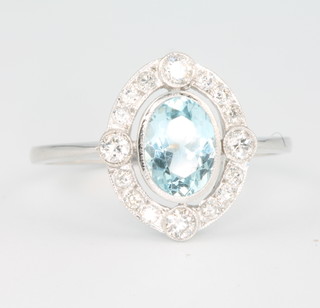 An 18ct white gold Art Deco style oval aquamarine and diamond ring size P 