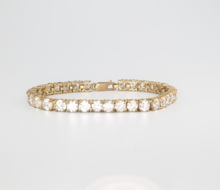 A 9ct yellow gold paste set tennis bracelet 170mm and a pair of ditto half hoop earrings