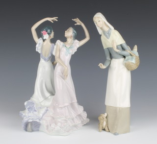 A Lladro figure of a standing lady with basket of French sticks 27cm and 1 other figure group of Flamenco dancers 27cm (fingers f)