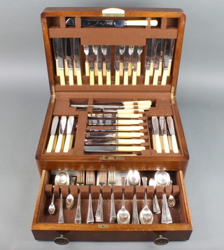 An Art Deco walnut canteen containing a set of silver plated cutlery for 12 