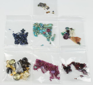 A quantity of loose precious and semi-precious stones including rubies, opals, amethysts etc 