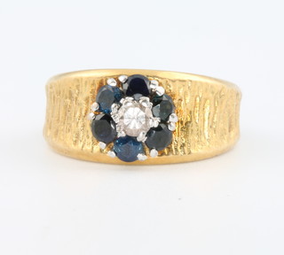 An 18ct yellow gold bark finished sapphire and diamond ring size J 