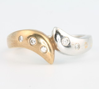A 9ct 2 colour gold diamond set cross-over ring size O 