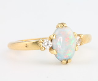 An 18ct yellow gold opal and diamond ring size M