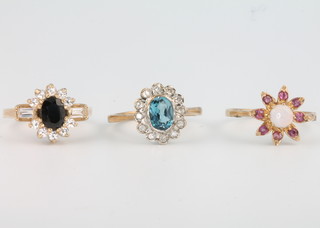 Three 9ct yellow gold gem set rings, sizes L, N and O 