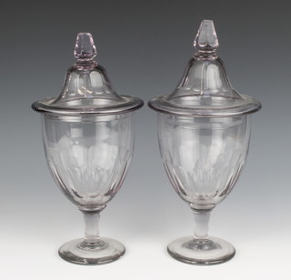 A pair of grey glass urns and covers, raised on circular spreading base, 12cm h  