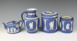 A Wedgwood Jasperware teapot (f&r) a cylindrical Jasperware biscuit barrel (f) 5 1/2"h, a jar 4" (no lid) and a jug 7"h (chips to the rim)