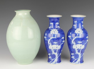 A pair of 19th Century Chinese blue and white prunus baluster shaped vases 26cm and a Celadon vase 30cm 