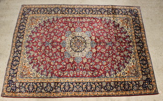 A blue and red ground floral patterned Persian carpet within a 5 row border 334cm x 247cm 