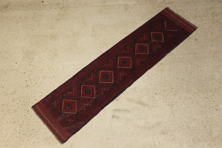 A blue and red ground Meshwani runner with 7 stylised octagons to the centre 240cm x 62cm 