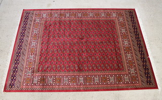 A red ground Belgian cotton Bokhara style rug with numerous octagons to the centre 280cm x 200cm 