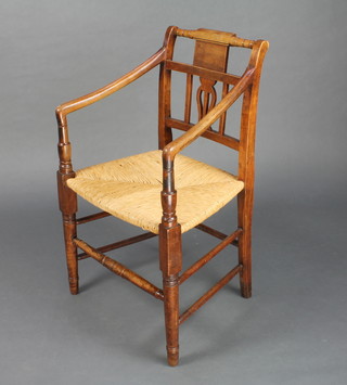 An 18th Century mahogany bar back chair with woven rush seat raised on turned supports 