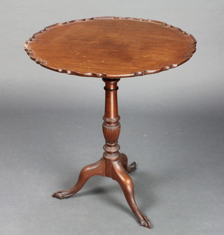 A Chippendale style circular snap top mahogany wine table with pie crust edge raised on turned column and tripod supports with egg and claw feet 70cm h x 61cm diam.