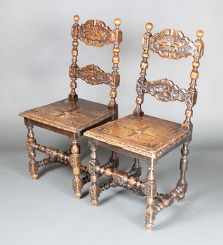 A pair of Victorian carved oak ladder back hall chairs with solid seats raised on carved turned and block supports with H framed stretchers 