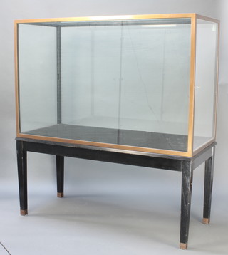 Edmonds of Birmingham and London, a museum quality rectangular bronze and plate glass display cabinet, raised on ebonised stand with gilt metal cappings, 183.5cm h x 168cm w x 71cm d 