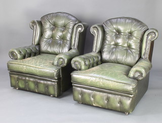A pair of hall armchairs upholstered in buttoned green leather