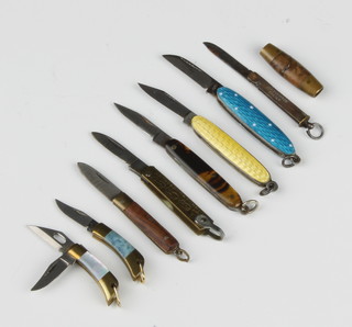 Eight miniature knives - 2 with enamelled grips, 1 knife with tortoiseshell, 1 with hardstone and mother of pearl fitted 2 blades, a Swedish barrel knife and 2 others 