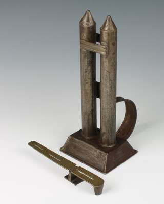An 18th/19th Century twin metal candle mould 23cm x 10cm x 8cm together with a brass balance 15cm 