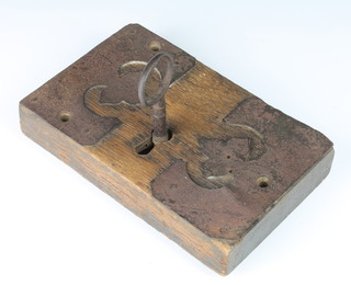 An 18th Century iron lock contained in an oak and steel mounted frame 14.5cm x 23cm x 4cm 