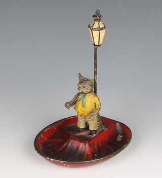 An Austrian cold painted bronze and tin plate ashtray in the form of a standing cat with articulated head beneath a lamp standard, raised on an oval tin plate base 15cm h x 11cm w x 10cm d (possibly the lid of a tobacco jar)