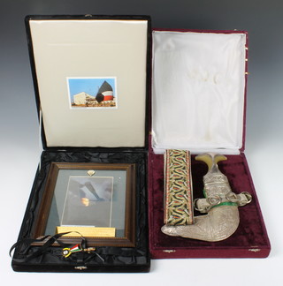 A Jambuyka with 18cm blade, horn grip, white metal scabbard and belt contained in a plush case together with a photographic image with brass plaque marked "We will never forget your sacrifice for the liberation of Kuwait, Kuwait National Embassy 1994" together with 2 enamel badges and a scrap of paper marked Lance Corporal Lee Wellington who died in Kuwait 1994 