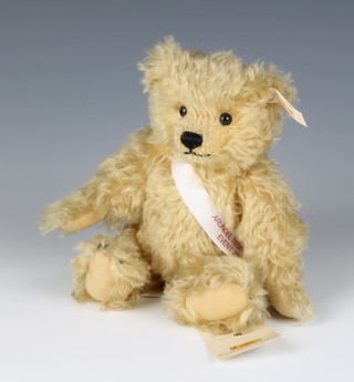 A Steiff yellow teddy bear with articulated limbs and sash marked Arundel teddy bear event 2000 21cm 