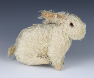 A 1930's musical figure of a seated rabbit 20cm x 20cm x 10cm 