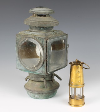 Of motoring interest, an American metal car lamp converted to electricity, the top marked E & J Detroit CH Patent DC9 1908 25cm x 12cm x 11cm (some corrosion) together with a miniature reproduction brass miner's safety lamp 12cm 
