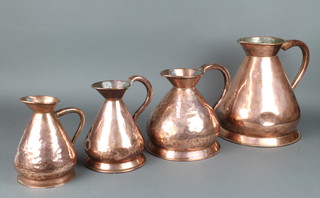 Four 19th Century associated polished copper harvest measures - a 2 gallon with George V mark, marked LCC 34cm h, a 1 gallon with lead mark 26cm  and 2  marked 1/2 gallon - one with George VI lead mark and stamped 39 24cm h, the other marked John Mack Glasham & Co Glasgow 23cm 