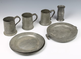 An Irish pewter waisted measure, the base with heart touch mark 12cm x 7cm, a pewter twin handled plate warmer with London touch mark 4cm x 23cm, a Victorian pewter pint tankard, 2 other pewter pint tankards and 3 pewter plates 25cm - 1 with London touch mark - all with some signs of corrosion 