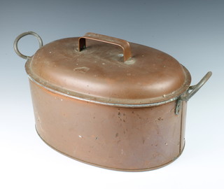 An oval twin handled copper fish kettle 26cm x 54cm x 32cm 
