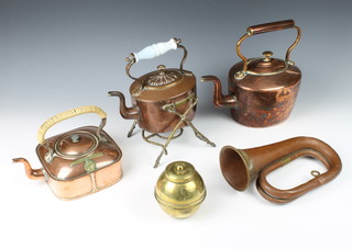 A The Davis Gas Stove Ltd flat bottomed rectangular copper teapot 7cm x 16cm x 17cm (some dents), a copper and brass spirit kettle with ceramic handle 20cm x 14cm x 20cm (chip to handle and burner missing), a Victorian oval copper kettle 30cm x 20cm x 15cm, a copper bugle (some dents), a Lipton's brass tea caddy to commemorate The British Empire Exhibition 1924  