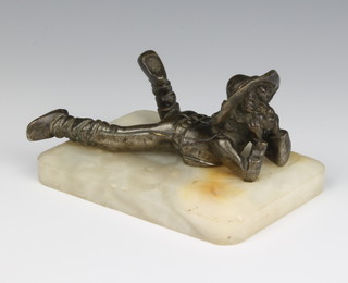 A spelter and marble paperweight decorated a reclining boy, raised on a marble base, 6cm h x 12cm w x 18cm, 