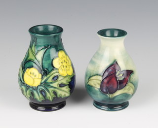 A contemporary Moorcroft baluster vase decorated with flowers on a green ground, do. decorated with tulips 9cm 