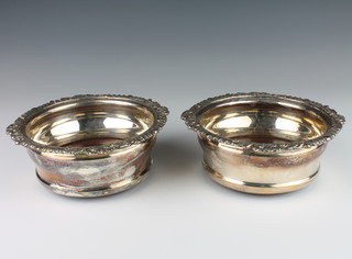 A pair of silver plated coasters with fancy rims 16cm 