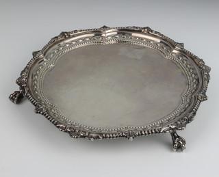 A silver card tray with scroll and dart rim on claw and ball feet, Birmingham 1947, 418 grams, 22cm 