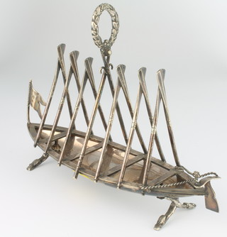 A Victorian novelty silver plated 7 bar toast rack in the form of a rowing boat with raised oars, having a laurel handle, engraved HAAC August 1893, 25cm 
