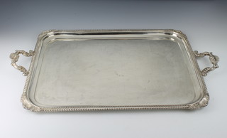 A rectangular silver twin handled tea tray with dragon borders, Sheffield 1927, maker Harrison Brothers & Howson, approx 4900 grams 