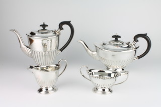 A silver 4 piece demi-fluted tea and coffee set with ebony mounts, Sheffield 1978, gross weight 1522 grams