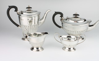 A silver 4 piece tea and coffee set with ebony mounts, Sheffield 1973, gross weight 1544 grams 