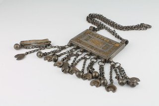 A middle Eastern silver and gold applied quran holder with tassels and bell decoration, 227 grams 