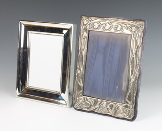 A repousse silver Art Nouveau style photograph frame, London 1979 29cm x 20cm together with a boxed plated Ralph Lauren rectangular ditto 25cm x 25cm  