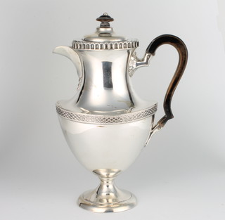 A repousse silver coffee pot of Adam style with fruitwood mounts, London 1918, gross weight 734 grams 27cm 
