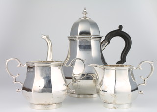 A silver Queen Anne style octagonal tea set comprising teapot, twin handled sugar bowl and cream jug with ebony mounts, London 1929, gross 1230 grams